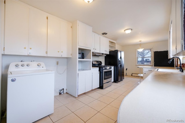 612 W Bijou Ave, Fort Morgan, CO 80701 - kitchen with washer / clothes dryer, stainless steel range with gas stovetop, white cabinets, light tile patterned floors, and light countertops