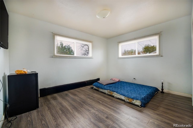 612 W Bijou Ave, Fort Morgan, CO 80701 - bedroom featuring wood finished floors and baseboards