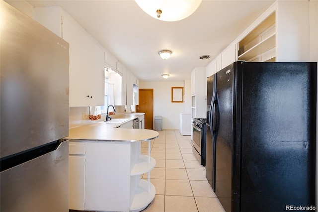 612 W Bijou Ave, Fort Morgan, CO 80701 - kitchen with stainless steel appliances, light tile patterned floors, light countertops, white cabinets, and open shelves