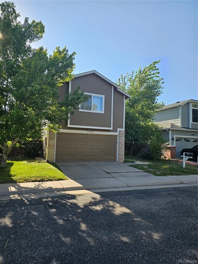 view of front facade with brick siding, driveway, and an attached garage