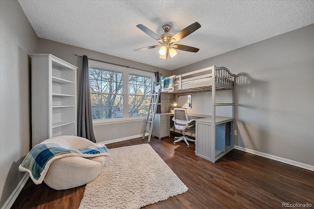 bedroom featuring ceiling fan, dark hardwood / wood-style floors, and a textured ceiling