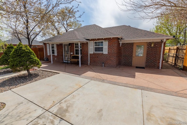 3021 Grape St, Denver, CO 80207 - back of property with brick siding, fence, and a shingled roof