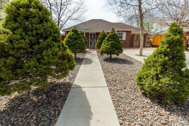 3021 Grape St, Denver, CO 80207 - view of front of home with fence, brick siding, and roof with shingles