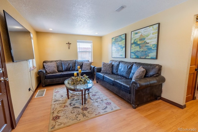 3021 Grape St, Denver, CO 80207 - living room featuring light wood-style flooring, baseboards, recessed lighting, and a textured ceiling