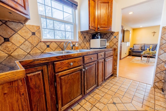 3021 Grape St, Denver, CO 80207 - kitchen with white microwave, a sink, tasteful backsplash, dark countertops, and recessed lighting