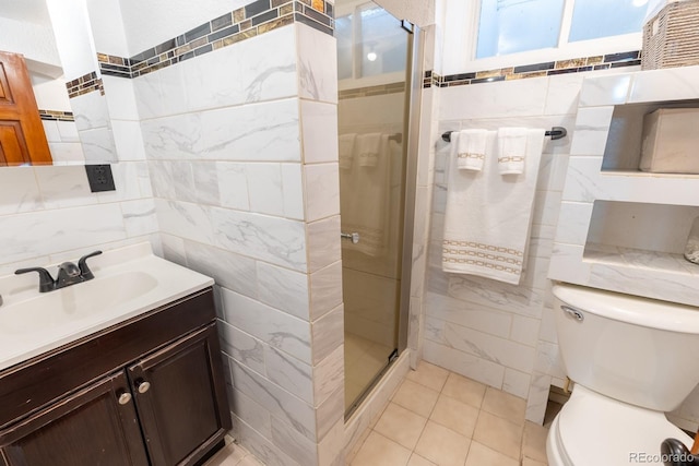3021 Grape St, Denver, CO 80207 - bathroom with tile walls, a stall shower, vanity, toilet, and tile patterned floors