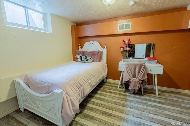 3021 Grape St, Denver, CO 80207 - bedroom featuring wood finished floors and a textured ceiling