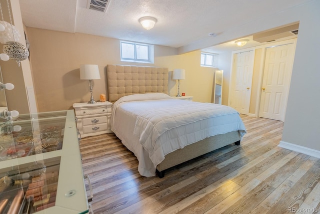 3021 Grape St, Denver, CO 80207 - bedroom featuring wood finished floors, a textured ceiling, and baseboards
