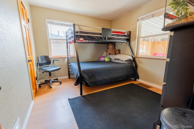 3021 Grape St, Denver, CO 80207 - bedroom with wood finished floors, a textured wall, and baseboards