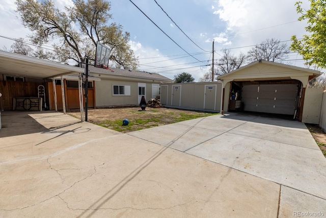 3021 Grape St, Denver, CO 80207 - view of front of property with concrete driveway, an outdoor structure, and a detached garage