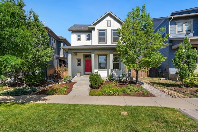 5068 Yosemite Ct, Denver, CO 80238 - view of front facade featuring board and batten siding, a front lawn, and a porch