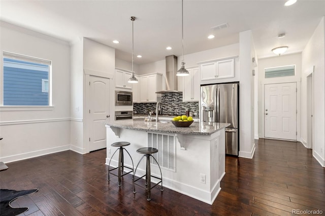 5068 Yosemite Ct, Denver, CO 80238 - kitchen featuring stainless steel appliances, wall chimney exhaust hood, dark wood-style flooring, backsplash, and recessed lighting