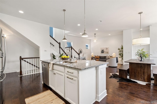 5068 Yosemite Ct, Denver, CO 80238 - kitchen featuring stainless steel appliances, dark wood-style flooring, light stone countertops, white cabinets, and a center island with sink