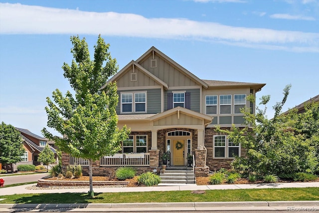 5663 W 96th Ave, Westminster, CO 80020 - craftsman-style home featuring board and batten siding, covered porch, and stone siding