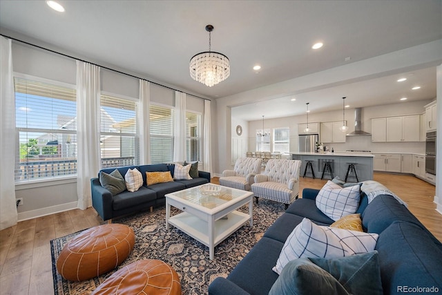 5663 W 96th Ave, Westminster, CO 80020 - living room with a chandelier, light wood finished floors, and recessed lighting