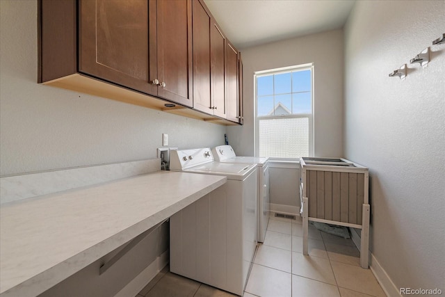 5663 W 96th Ave, Westminster, CO 80020 - washroom with cabinet space, washer and clothes dryer, and light tile patterned floors