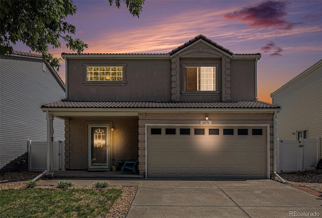 4076 Andes Way, Denver, CO 80249 - traditional-style home featuring covered porch, driveway, a garage, and a tile roof