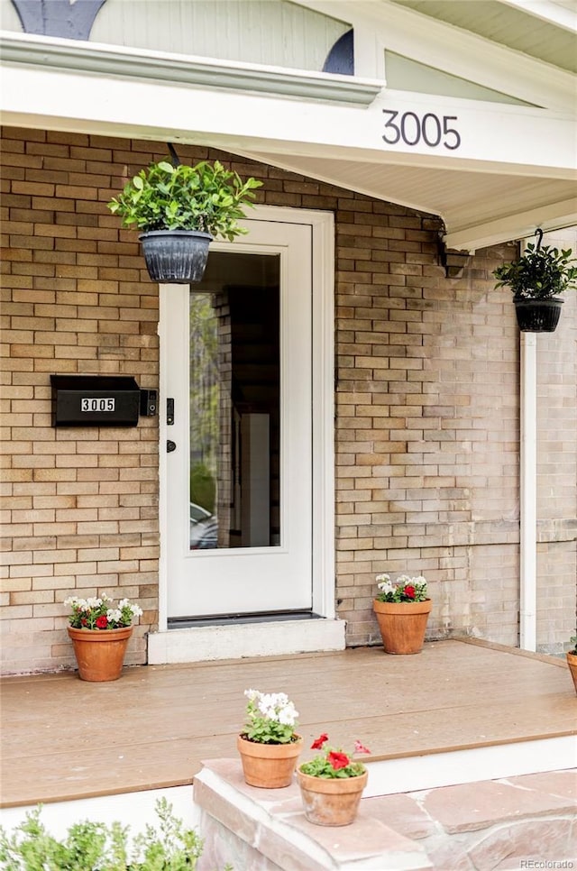 entrance to property with brick siding