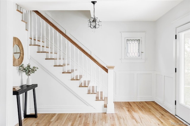 foyer entrance featuring stairway, plenty of natural light, and wood finished floors