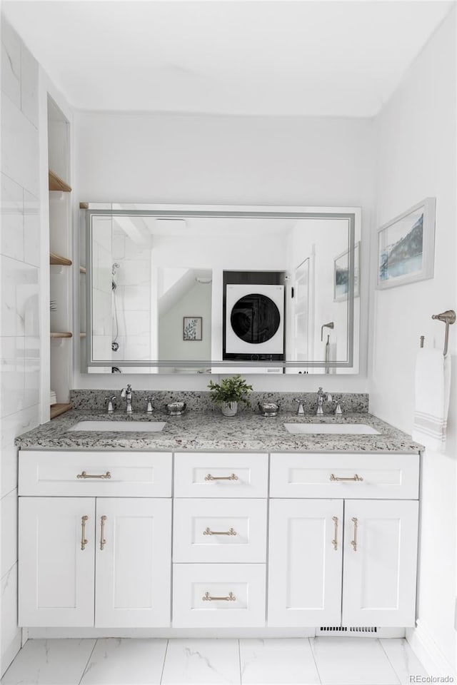 full bath with a sink, a shower, double vanity, and marble finish floor
