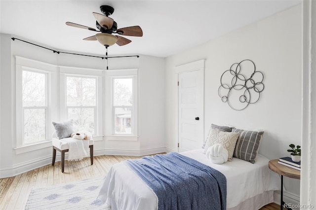 bedroom featuring baseboards, ceiling fan, and hardwood / wood-style flooring