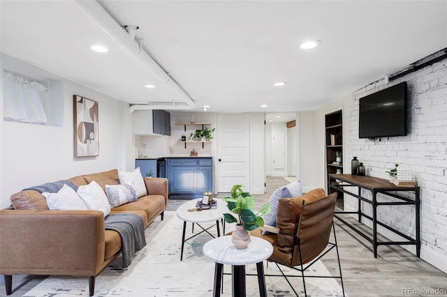 living room with built in features, baseboards, light wood-type flooring, and recessed lighting