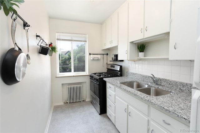 85 N Grant St Unit 27, Denver, CO 80203 - kitchen featuring radiator, gas stove, open shelves, tasteful backsplash, and white cabinetry
