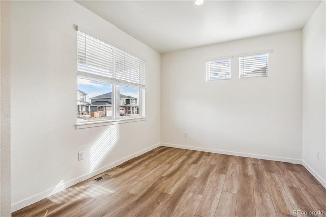 27684 E Byers Ave, Aurora, CO 80018 - unfurnished room featuring healthy amount of natural light, wood finished floors, and baseboards