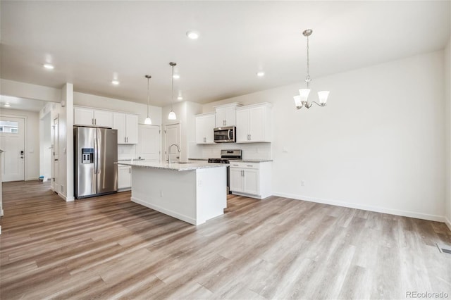 27684 E Byers Ave, Aurora, CO 80018 - kitchen with stainless steel appliances, a chandelier, light wood-type flooring, white cabinets, and recessed lighting
