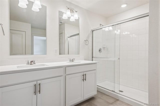 27684 E Byers Ave, Aurora, CO 80018 - full bathroom featuring a shower stall, double vanity, and tile patterned flooring