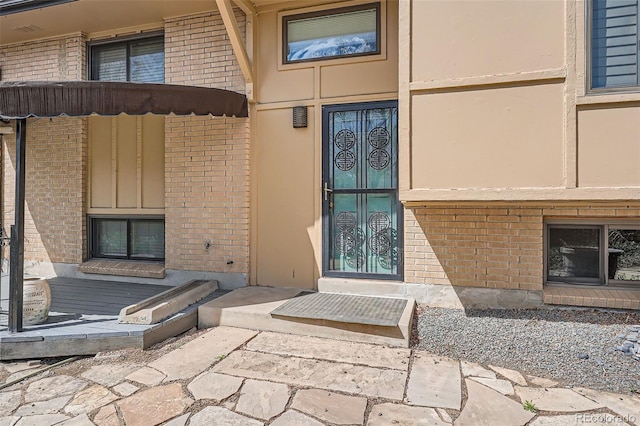 8095 E Lehigh Ave, Denver, CO 80237 - property entrance featuring brick siding and stucco siding