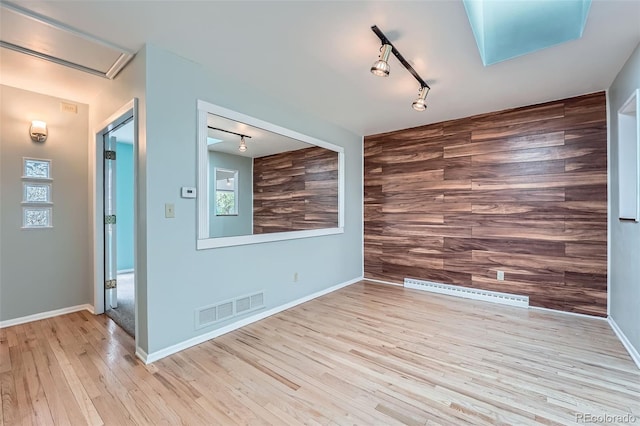 8095 E Lehigh Ave, Denver, CO 80237 - unfurnished room with track lighting, wood finished floors, and plenty of natural light