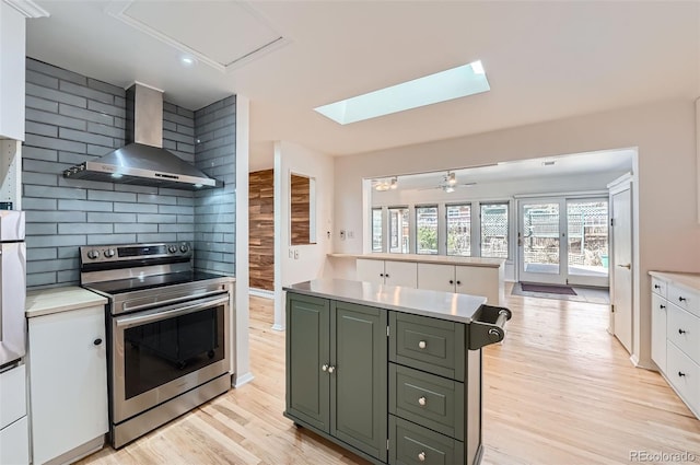 8095 E Lehigh Ave, Denver, CO 80237 - kitchen with electric range, wall chimney range hood, white cabinetry, and light countertops