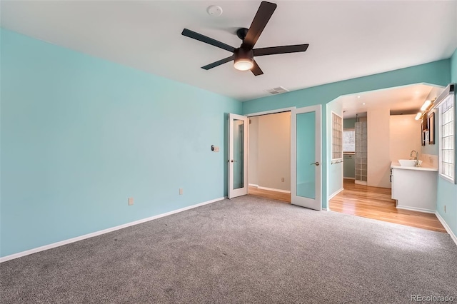 8095 E Lehigh Ave, Denver, CO 80237 - unfurnished bedroom with light colored carpet, baseboards, ceiling fan, a closet, and a sink