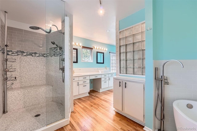 8095 E Lehigh Ave, Denver, CO 80237 - bathroom with a shower stall, wood finished floors, a freestanding bath, and vanity