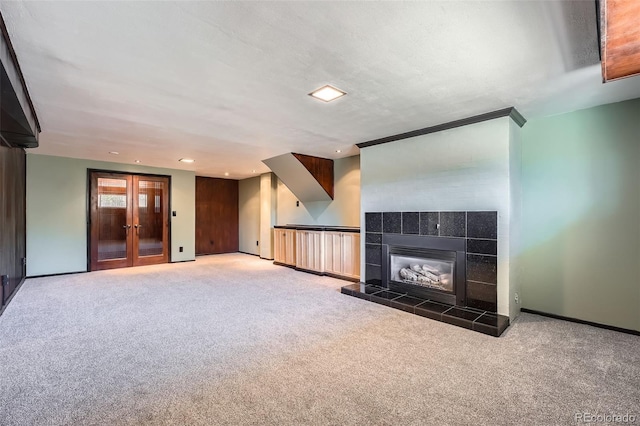 8095 E Lehigh Ave, Denver, CO 80237 - unfurnished living room with carpet floors, a fireplace, baseboards, recessed lighting, and french doors