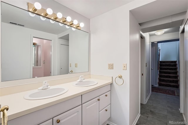 8095 E Lehigh Ave, Denver, CO 80237 - bathroom featuring double vanity and baseboards