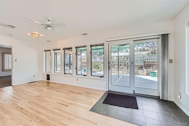 8095 E Lehigh Ave, Denver, CO 80237 - doorway to outside featuring baseboards, wood finished floors, and a ceiling fan