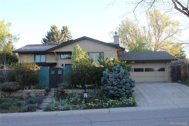 8095 E Lehigh Ave, Denver, CO 80237 - view of front of property with a chimney, driveway, an attached garage, and fence