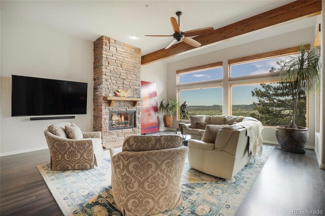 living room featuring beamed ceiling, ceiling fan, hardwood / wood-style floors, and a fireplace