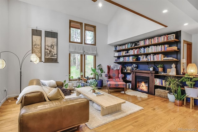 23646 Genesee Village Rd, Golden, CO 80401 - living room with wood finished floors, high vaulted ceiling, recessed lighting, a glass covered fireplace, and baseboards