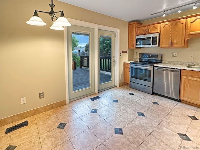 9236 W Euclid Ave, Littleton, CO 80123 - kitchen with appliances with stainless steel finishes, light countertops, a sink, light tile patterned floors, and baseboards