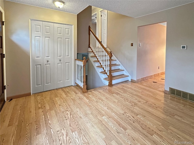 9236 W Euclid Ave, Littleton, CO 80123 - foyer entrance with a textured ceiling, wood finished floors, and baseboards