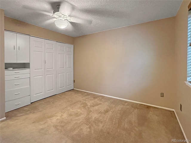 9236 W Euclid Ave, Littleton, CO 80123 - unfurnished bedroom with light colored carpet, baseboards, a closet, and a textured ceiling