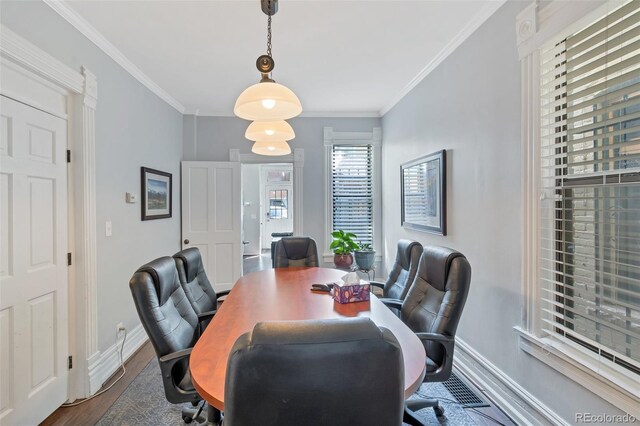 dining area with hardwood / wood-style flooring and ornamental molding