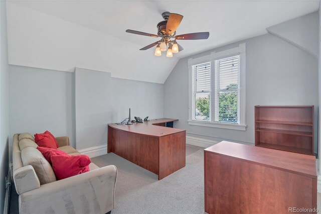 carpeted office space featuring ceiling fan and vaulted ceiling