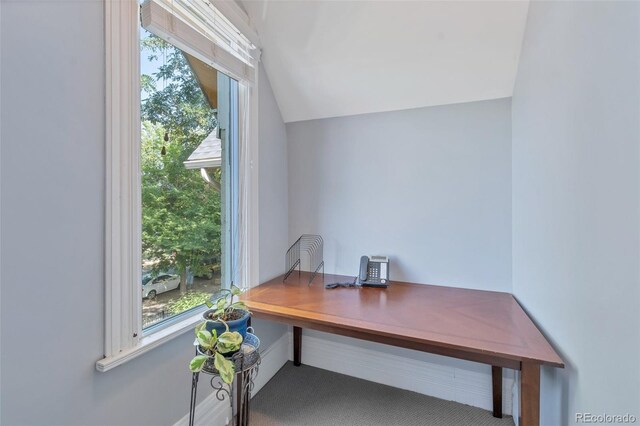 carpeted office featuring lofted ceiling