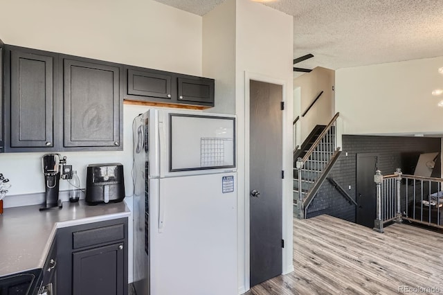 kitchen featuring light wood-style flooring and a textured ceiling