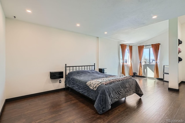 bedroom with lofted ceiling, recessed lighting, wood finished floors, and baseboards