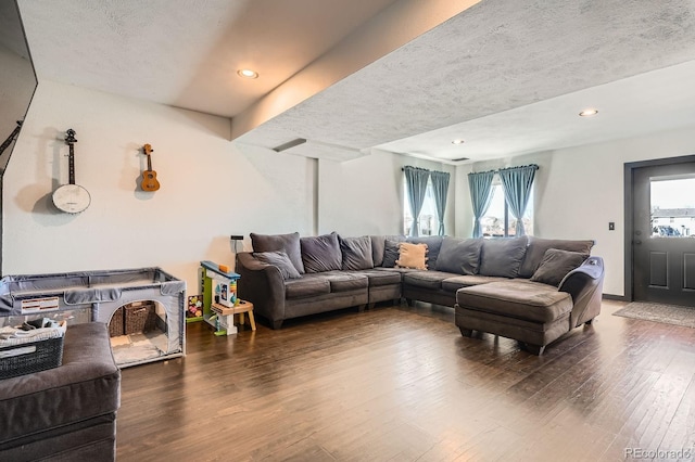 living area with recessed lighting, a textured ceiling, and wood finished floors